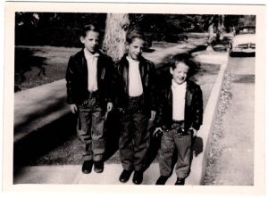 Three brothers standing on a street