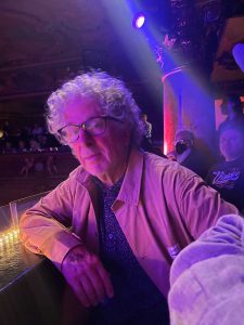 Joel Brokaw sitting on balcony at a theater